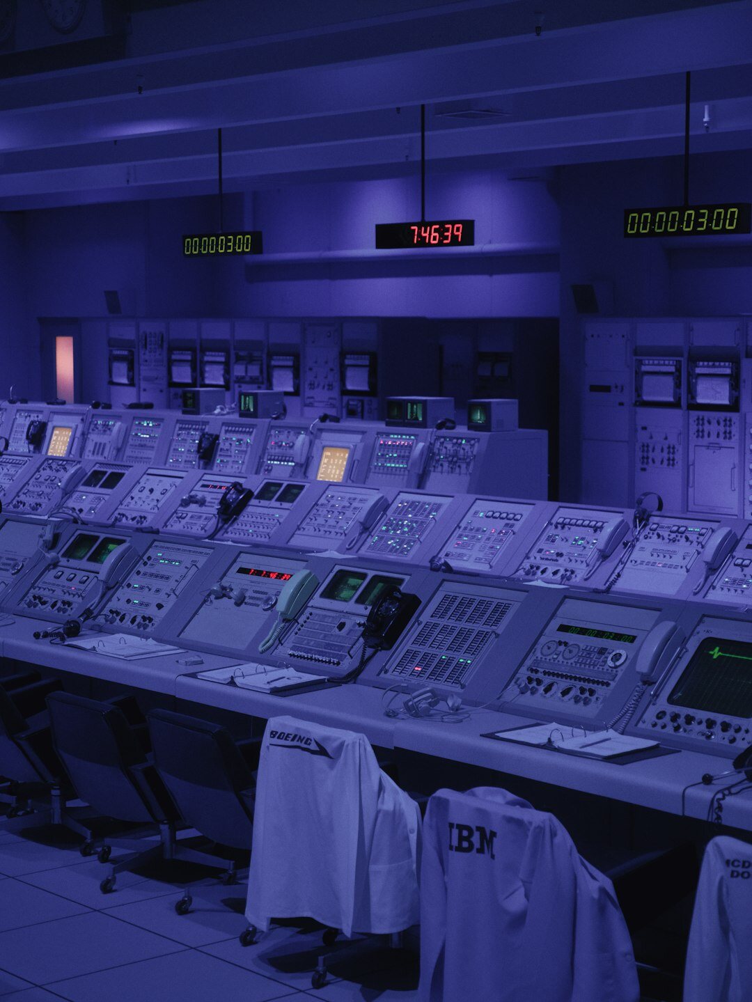 Vintage television studio control room with rows of monitors and mixing consoles